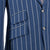 Close-up of a blue pinstripe suit jacket with buttons and pocket details.
