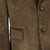 Close-up of a brown corduroy jacket with buttons and a pocket.