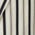 Close-up of striped fabric with black and beige stripes on a neutral background