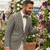 Man in a striped suit examining flowers at an RHS event